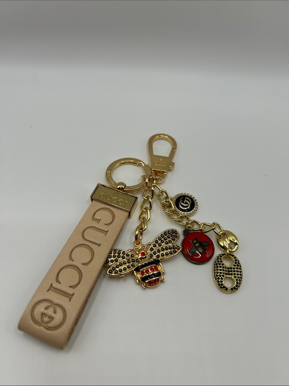 1462. Beige Leather Strap Keychain with Gold Bee and Red Enamel Charm